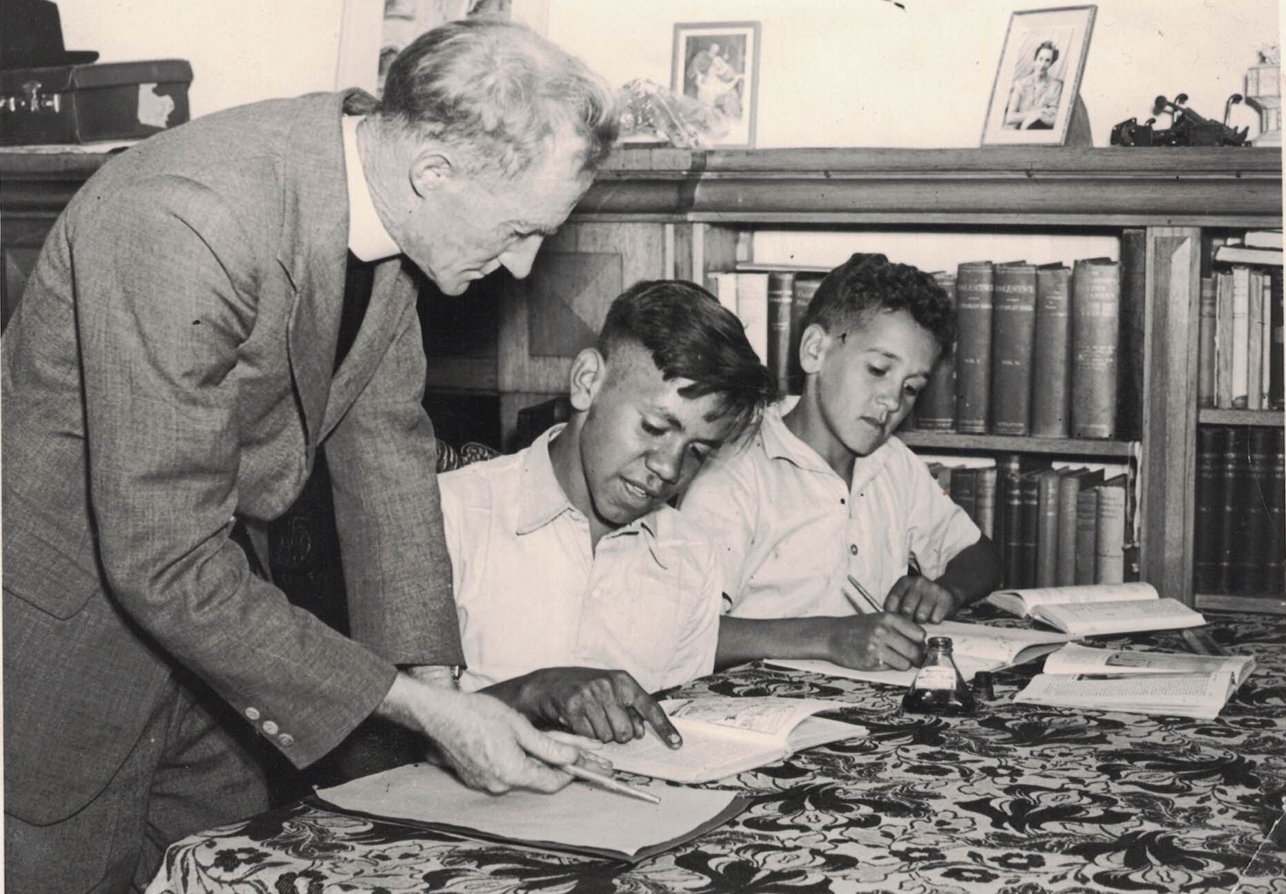 1947 – Father Smith assists Malcolm Cooper and Charles Perkins with their homework at St Francis House