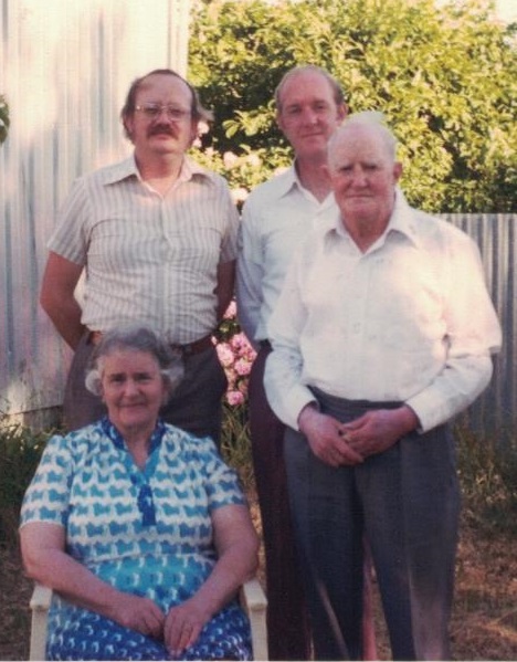 Phillip Sunman, the ‘White Brother’ of John P McD Smith standing at left. Isabel Smith is seated. Photo taken in 1980